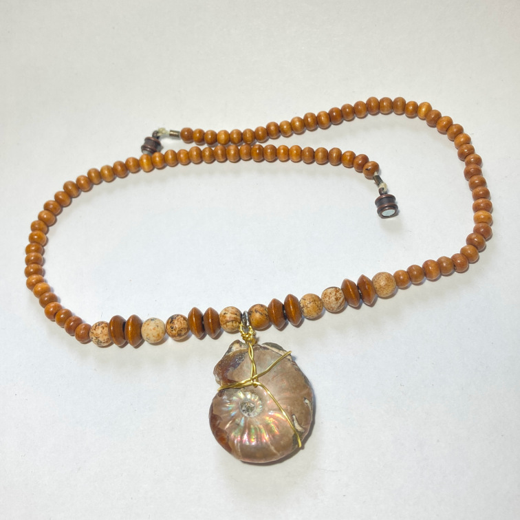 Wire wrapped ammonite with wood and stone beads
