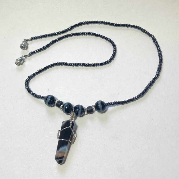 Black onyx point with small hand-threaded beads