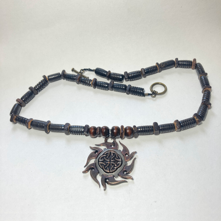 Intricate Celtic-inspired pendant with textured wooden beads