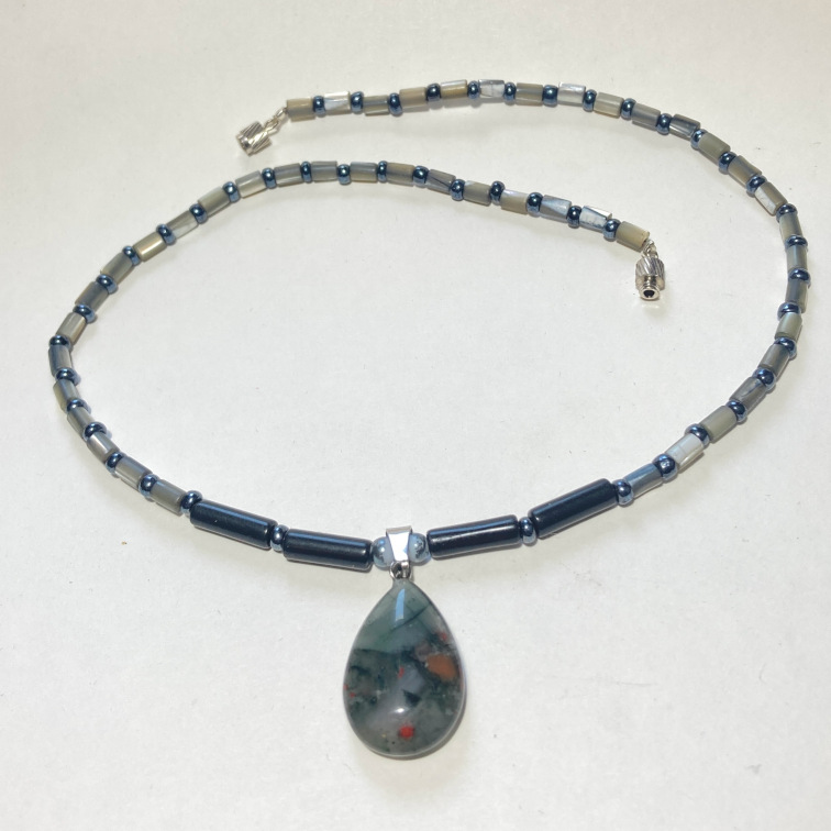 Dark stone pendant with alternating mother-of-pearl and hematite beads