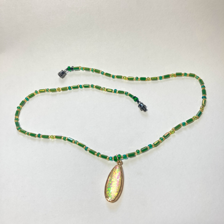 Glass metal-backed pendant with small glass beads