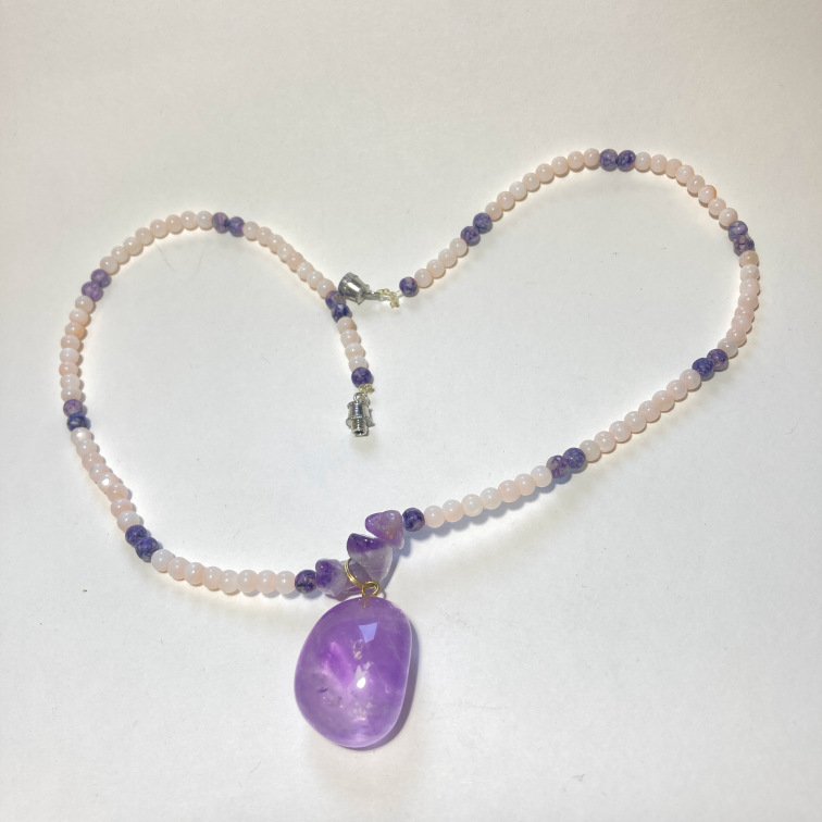 Polished amethyst chunk with small stone beads